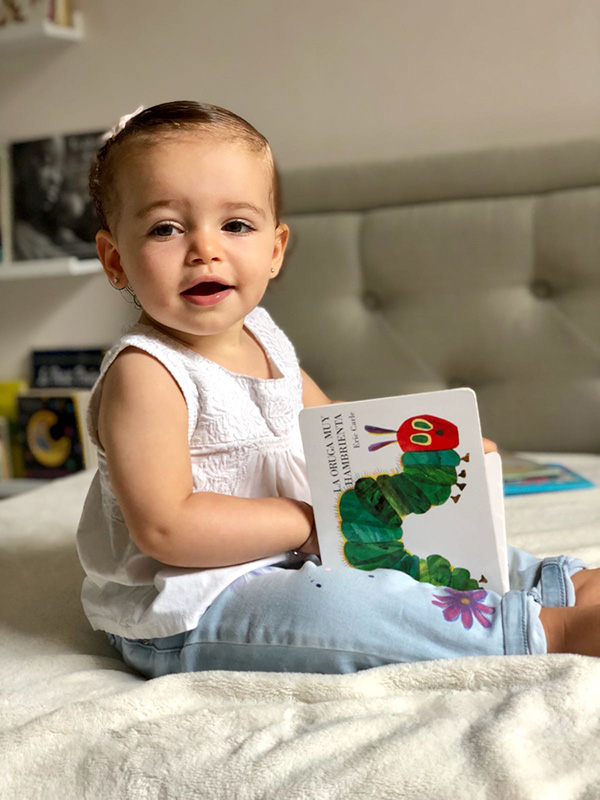 Baby girl holding a book