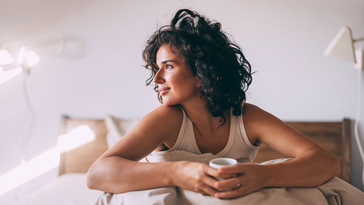 Woman sitting up in bed