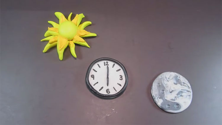 Claymation of sun, clock and moon